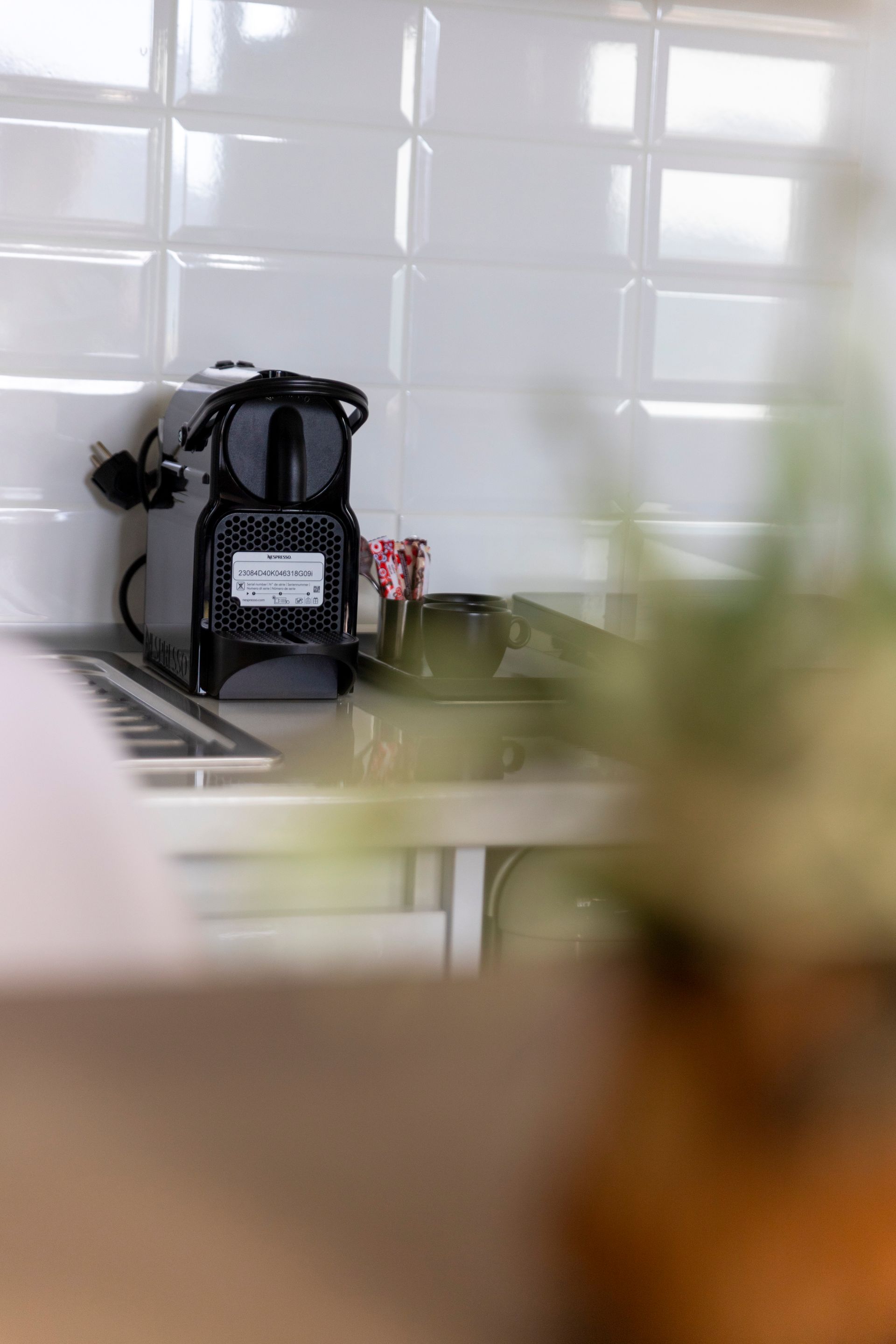 A coffee maker is sitting on a counter in a kitchen.
