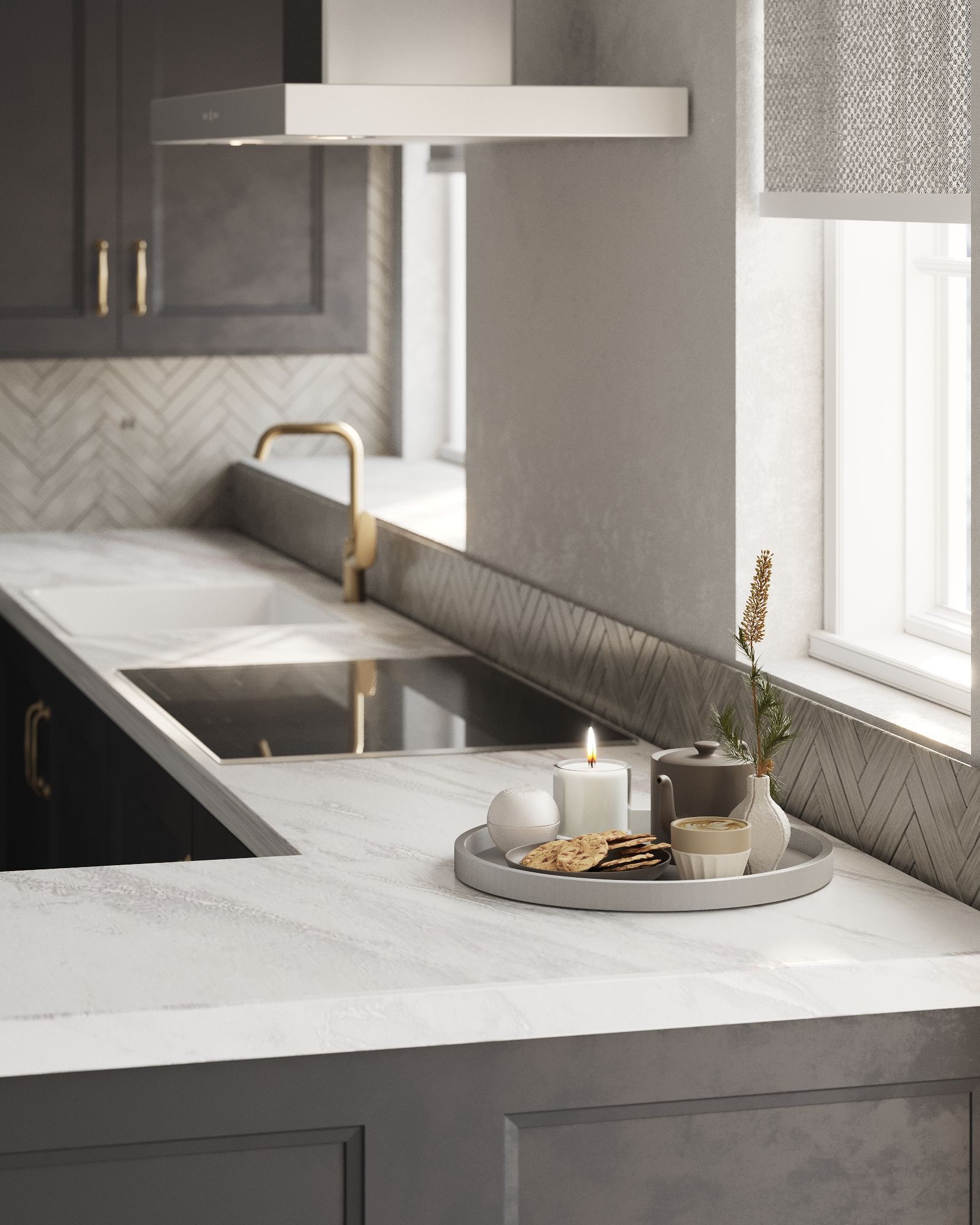 Close‑up of white kitchen worktop with herringbone splashback, brass tap and styled tray with candle, tea and biscuits