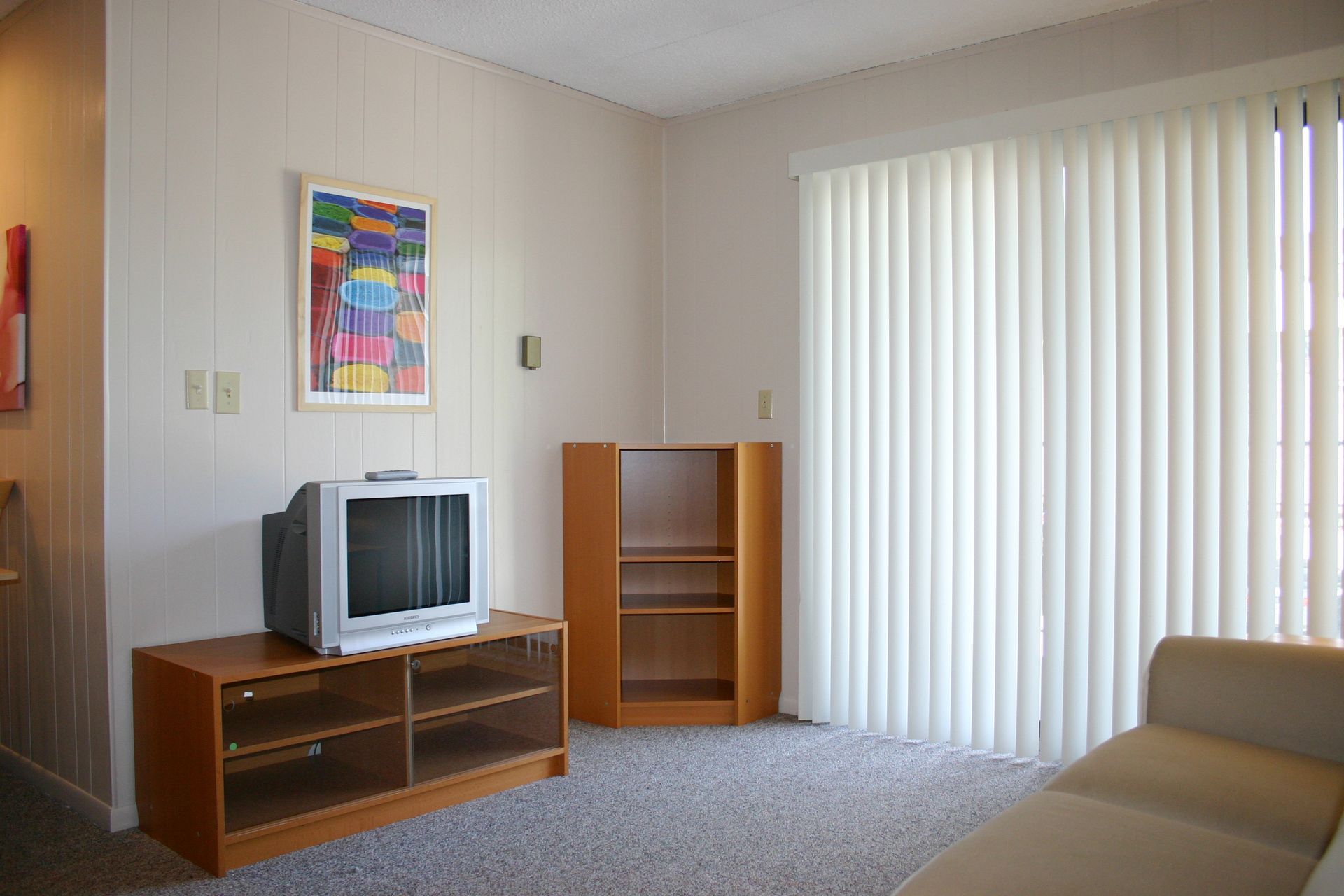 Photo showing a living room with plenty of natural lighting and a small, cozy feel
