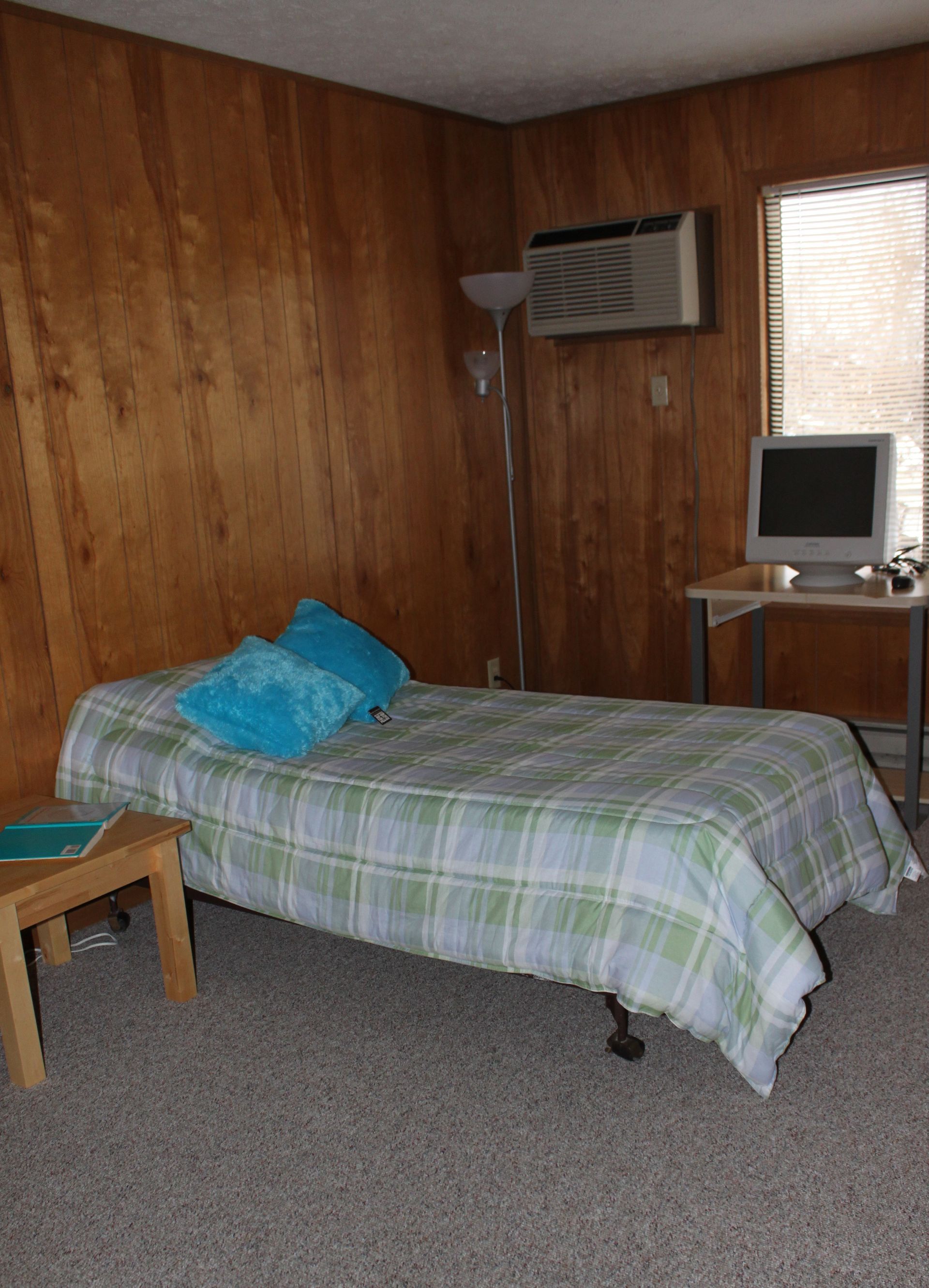 Photo showing a wood panel walled-bedroom
