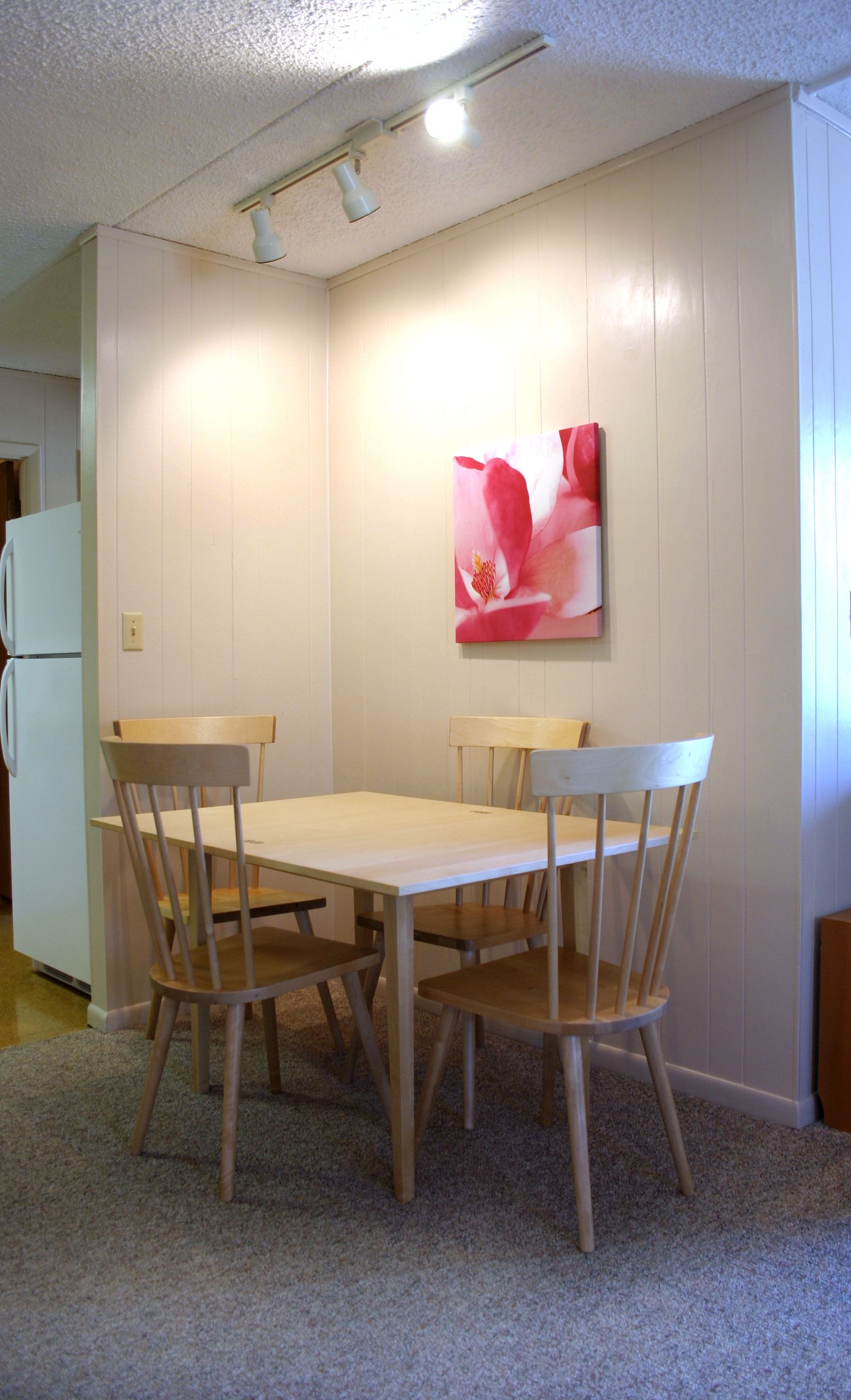 Photo showing a dining area with four chairs present