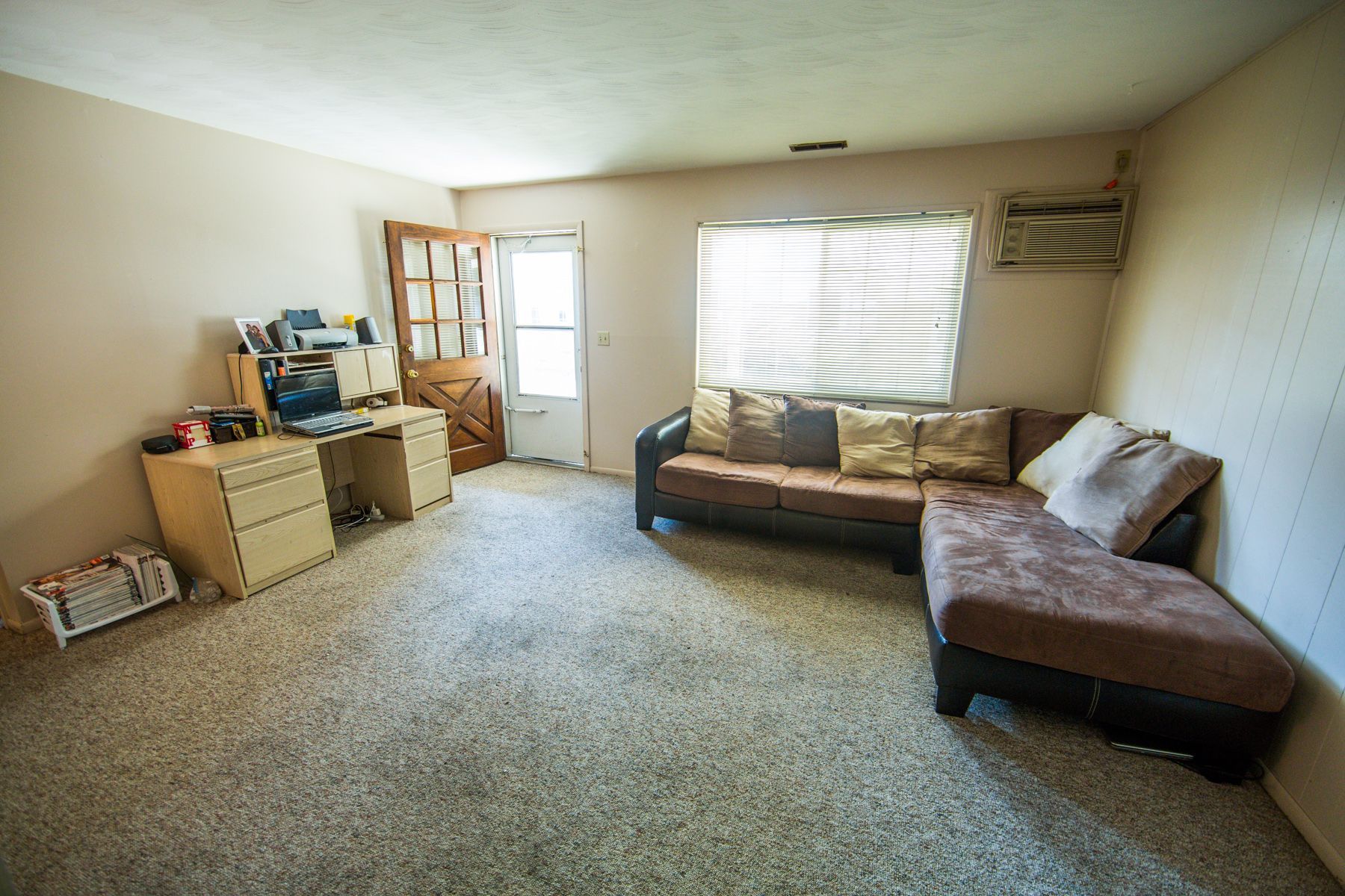 Photo showing a living room with a screen door