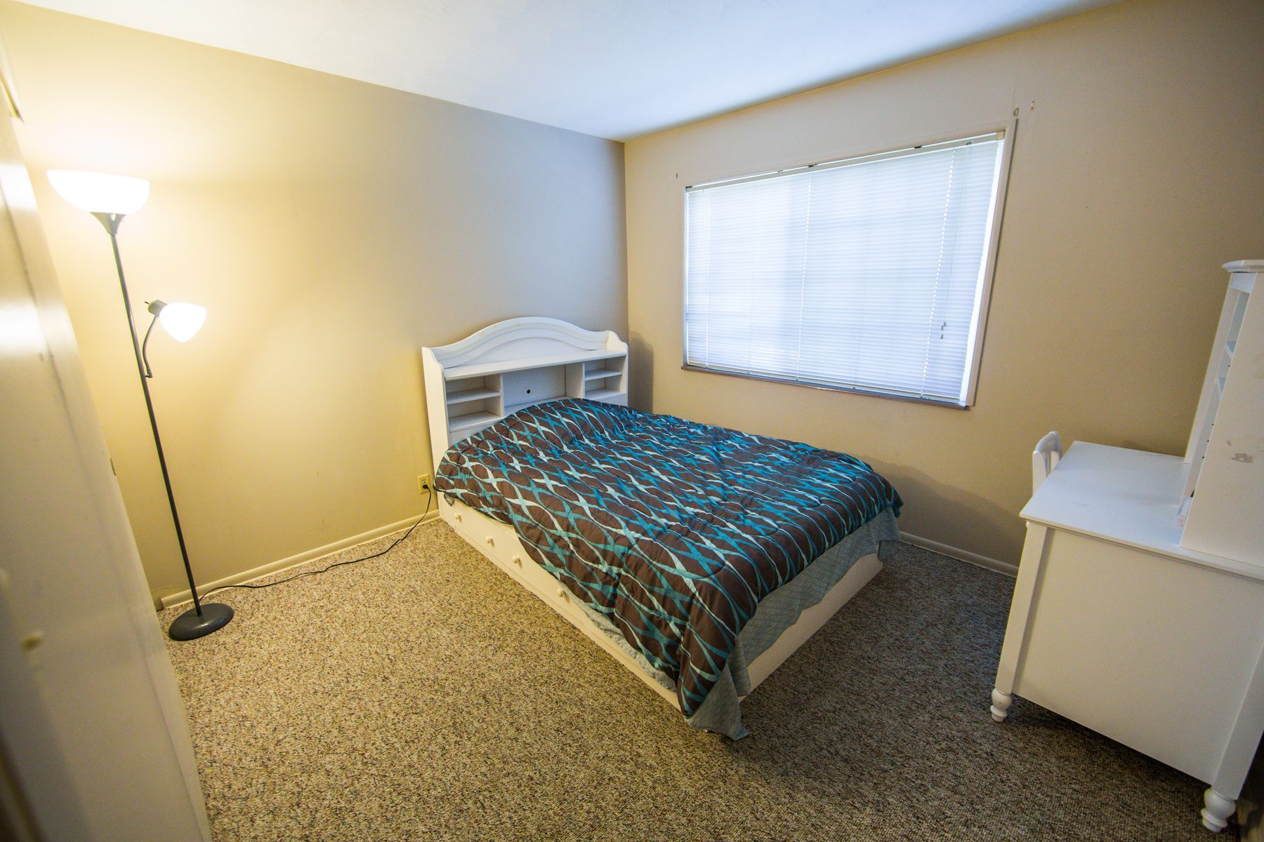 Photo showing a bedroom with a wide window