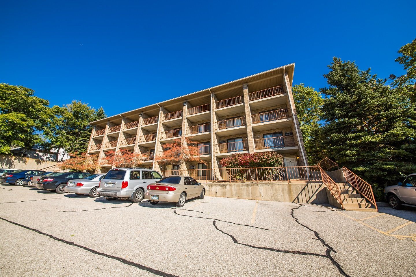 Photo showing a parking lot in the foreground and a building in the middleground