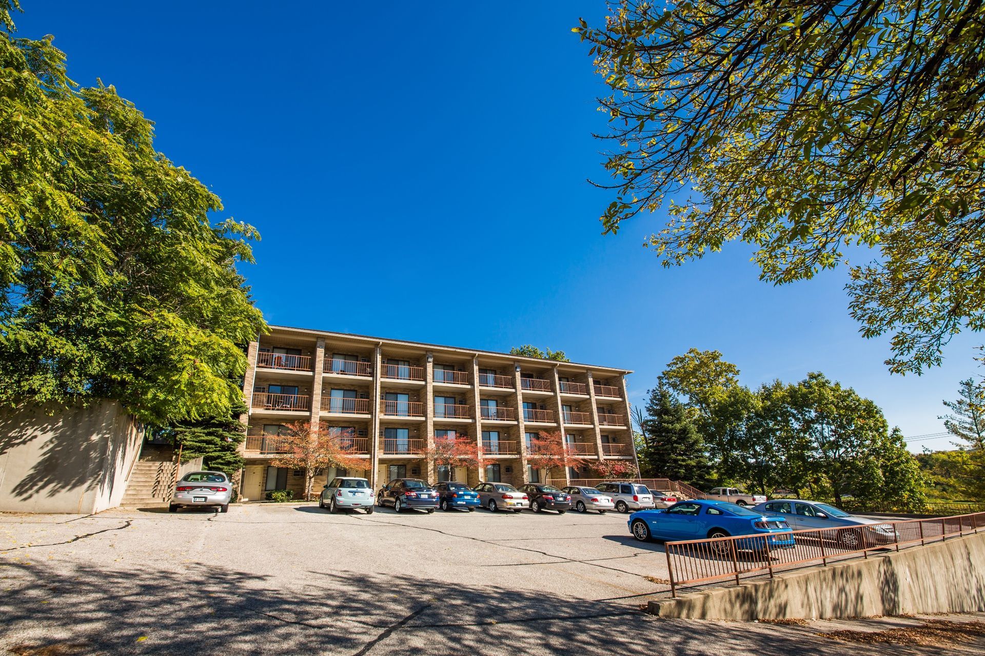 Photo showing a building with a large parking lot in front of it