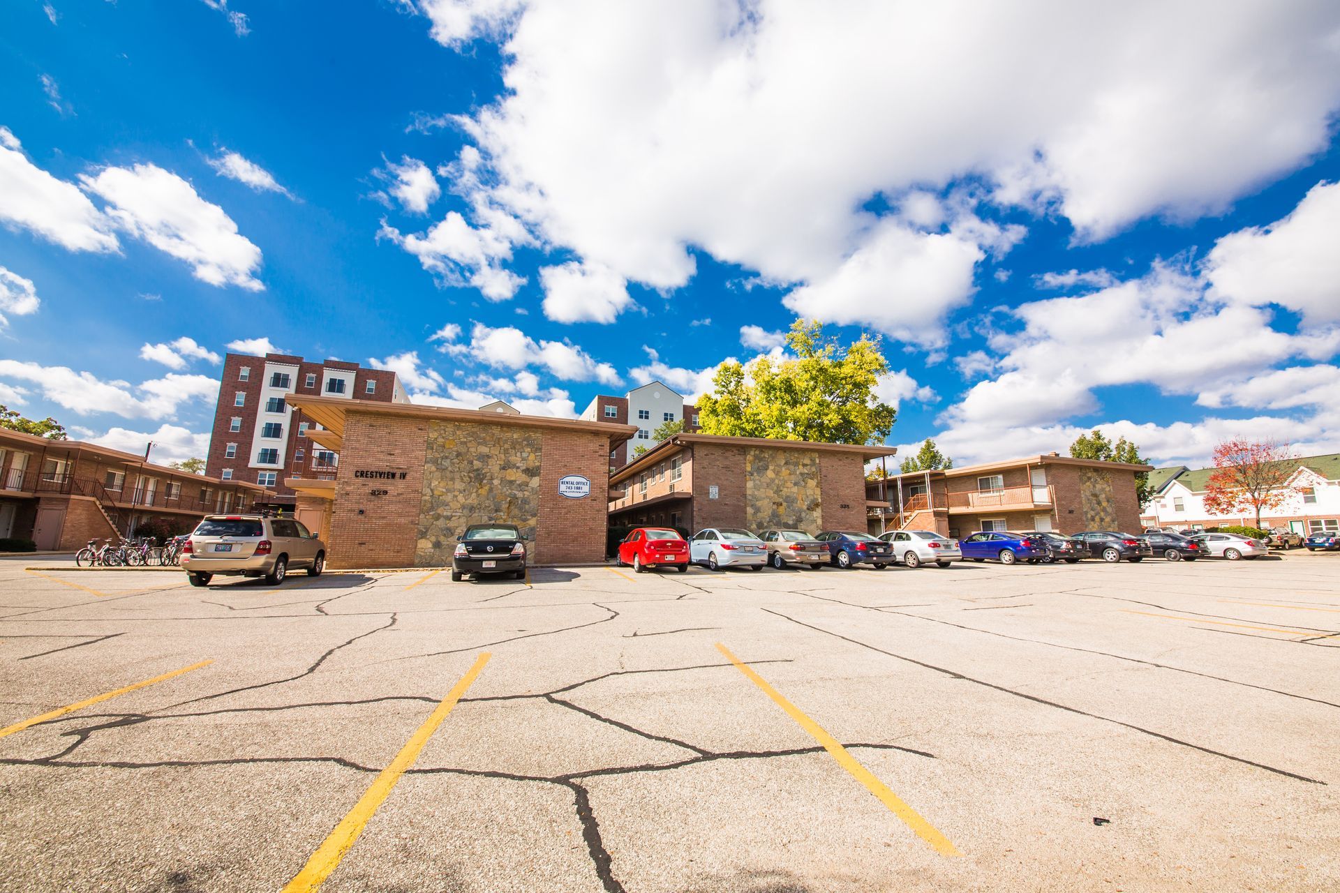 Photo showing a parking lot with a group of buildings in the background