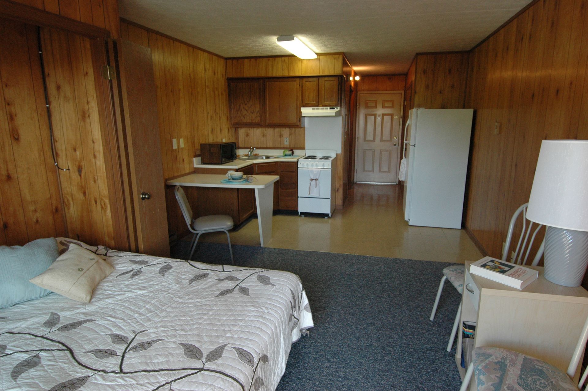 Photo showing a studio apartment from the perspective of the far end of the room