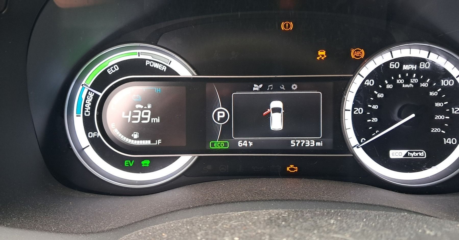 Car dashboard display showing 39 miles to empty, fuel indicator, and warning lights illuminated