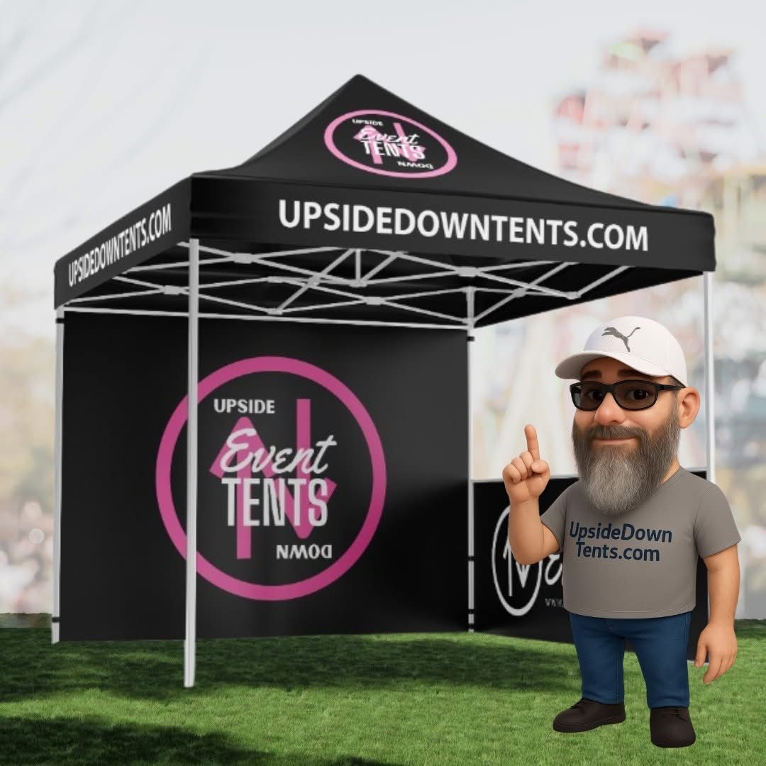 Black event tent with “UPSIDEDOWNTENTS.COM” branding and a small cartoon man on grass.