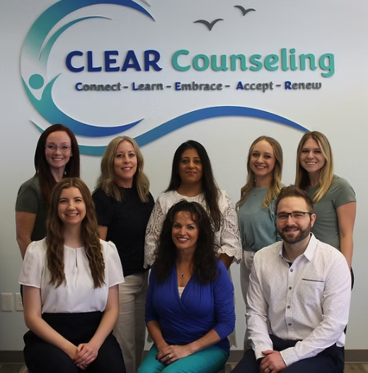 Group of counselors in front of a logo that reads
