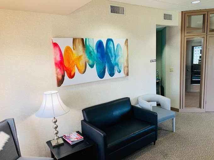 a waiting room with a colorful painting on the wall