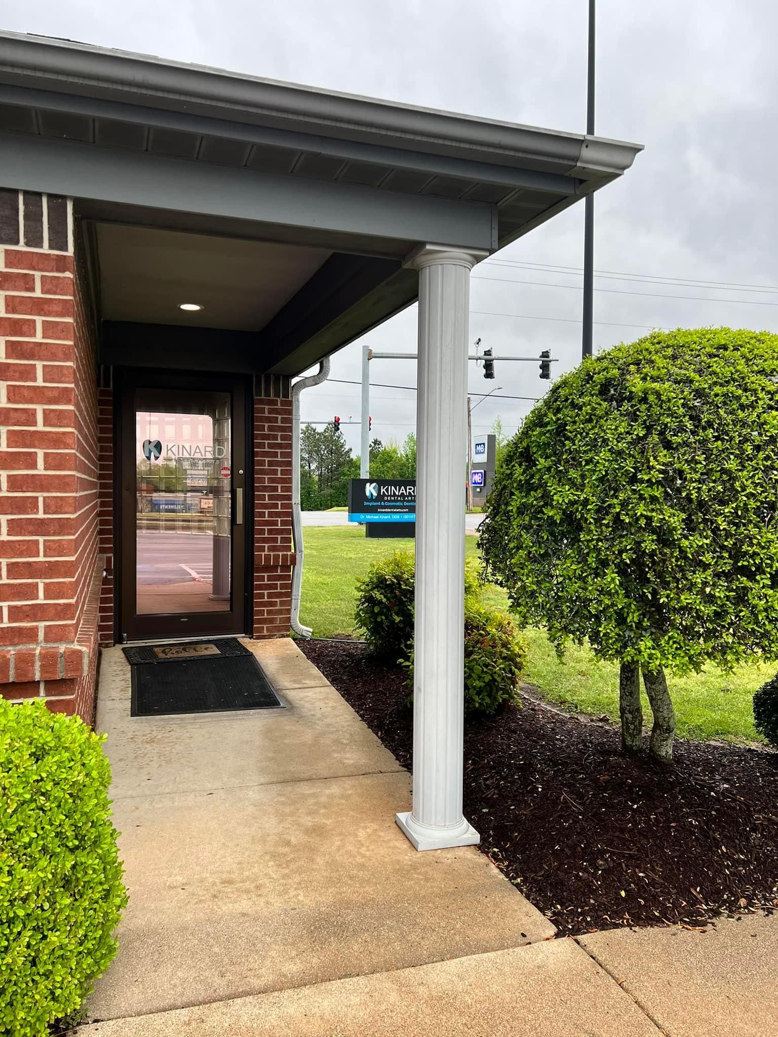 a brick building with a porch and a door .