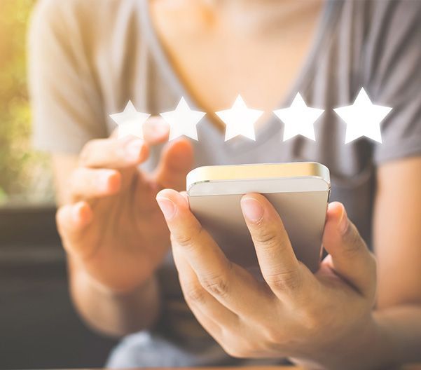 a woman is holding a cell phone with three stars on it .