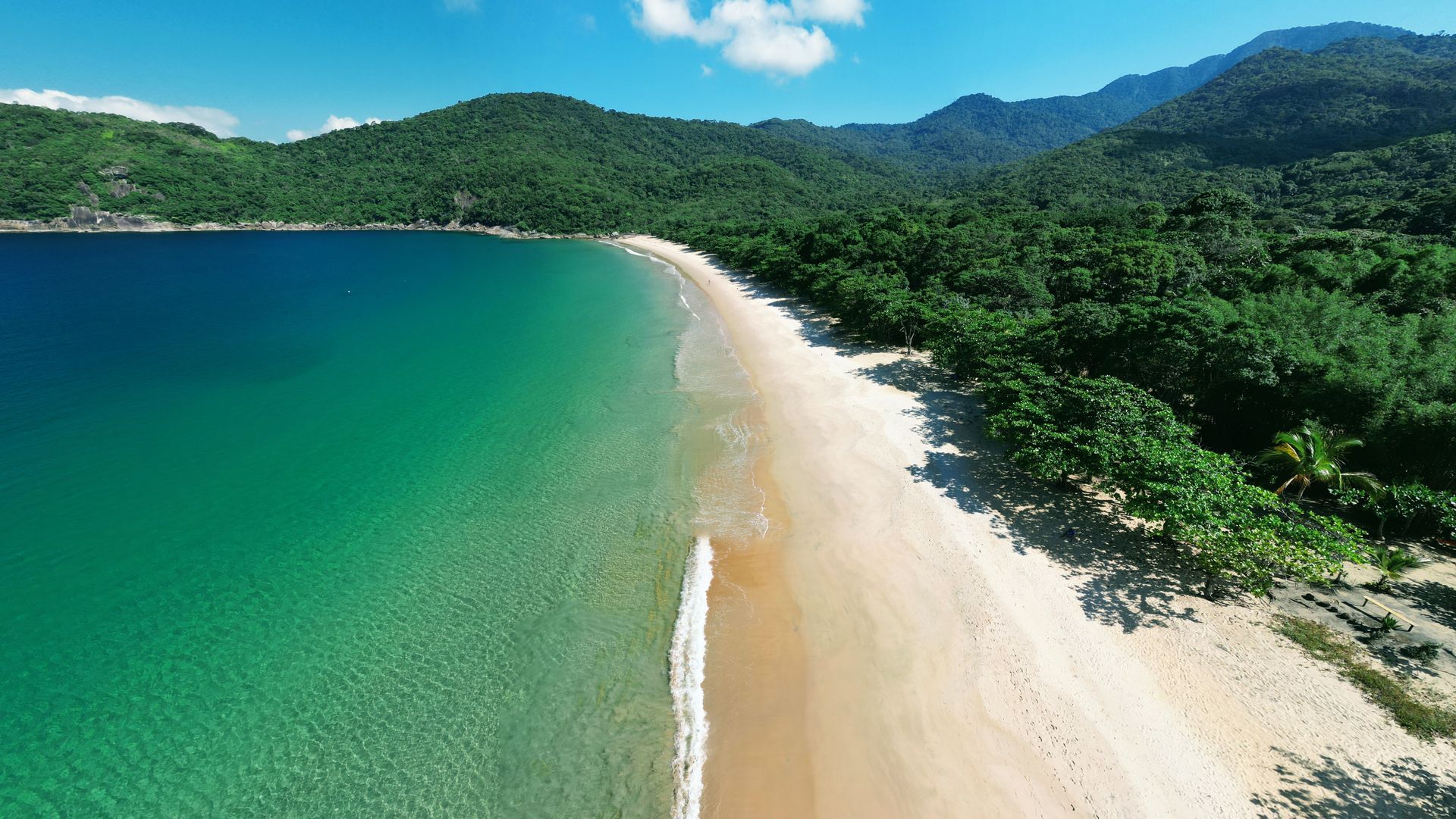 Aerial view of Parnaioca Beach in Ilha Grande, with a long sandy shore, Atlantic Forest and turquois