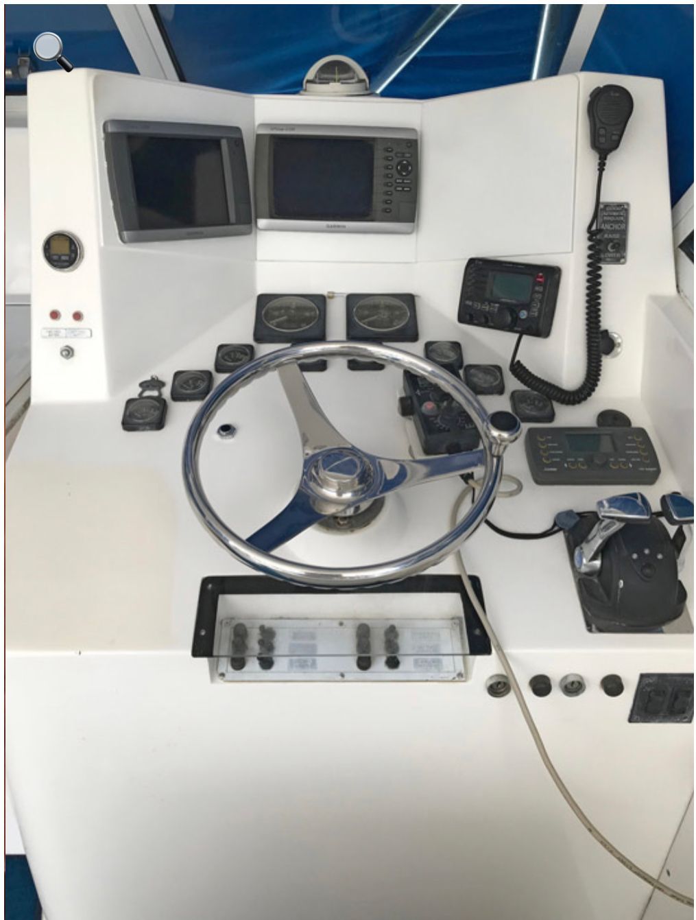 Helm station with the steering wheel, GPS, and fish finder