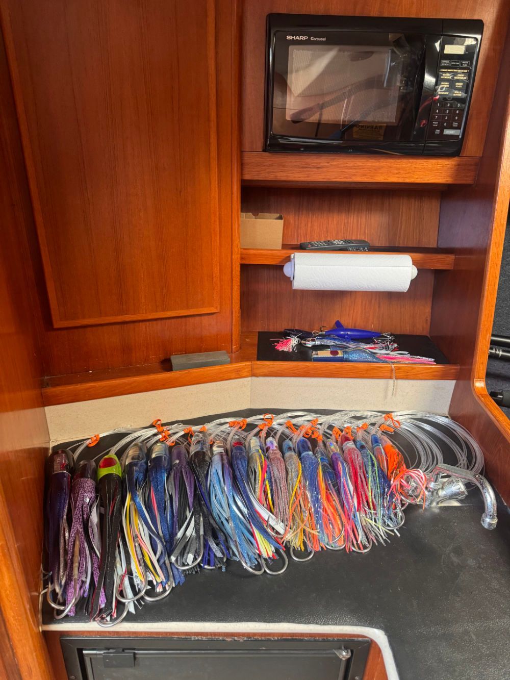 A rack of colorful trolling lures rigged and ready aboard the boat