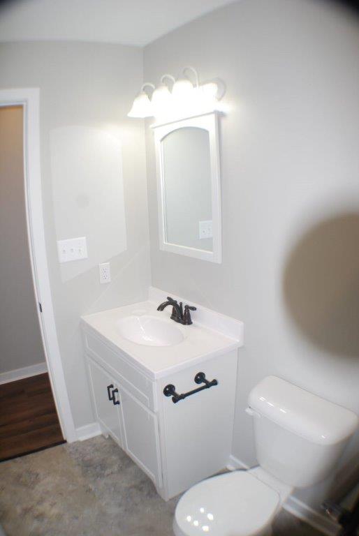 Toilet With Bathroom Sink, Mirror & Wooden Floor Outside — Manchester, PA — Keystone Restorations & Builders, Inc