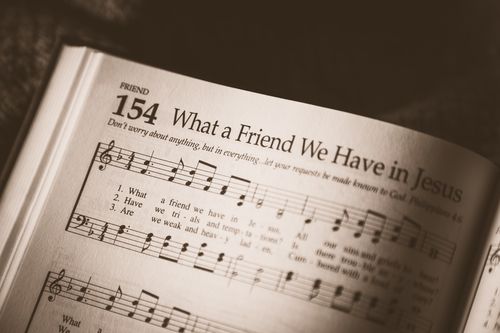 Open hymnbook page showing musical notes and the title