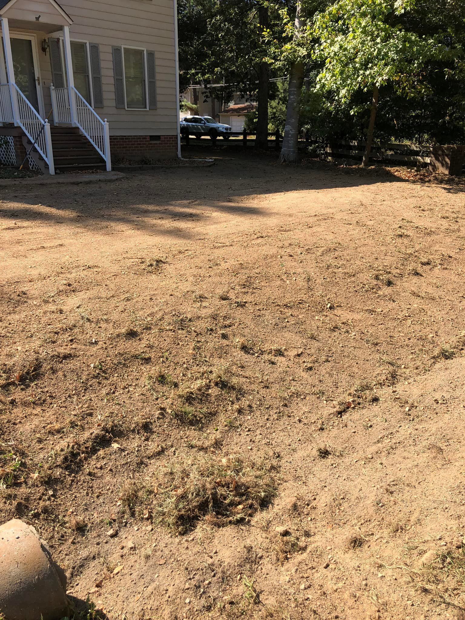 A house with a lot of dirt in front of it.