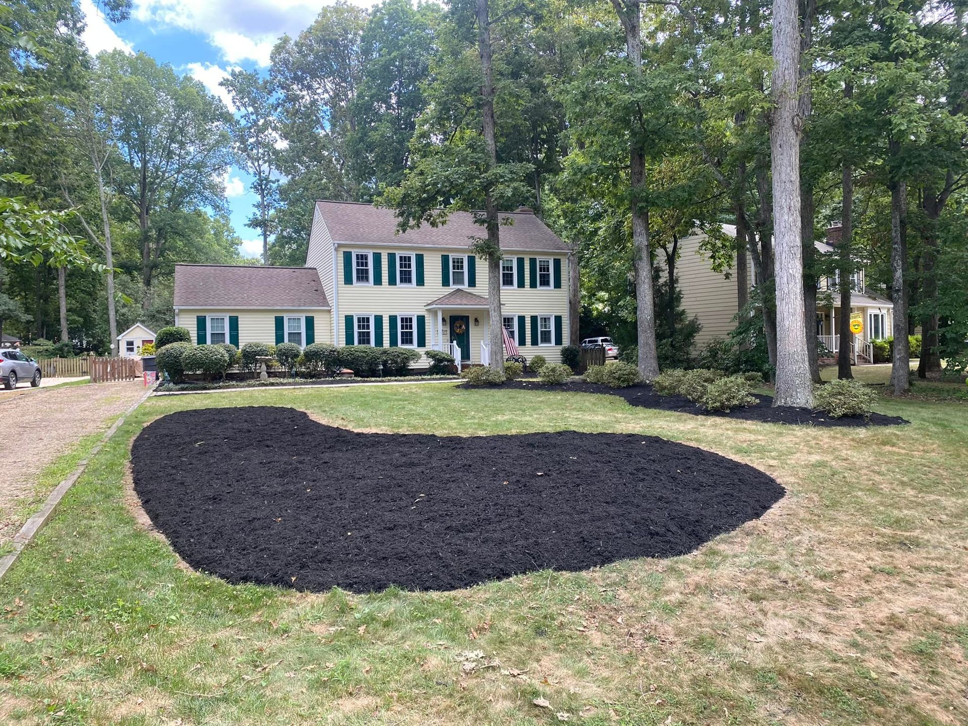 A large house with a lot of mulch in front of it.