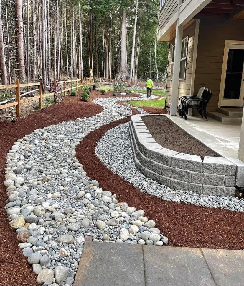 A stone walkway leading to a house in the woods