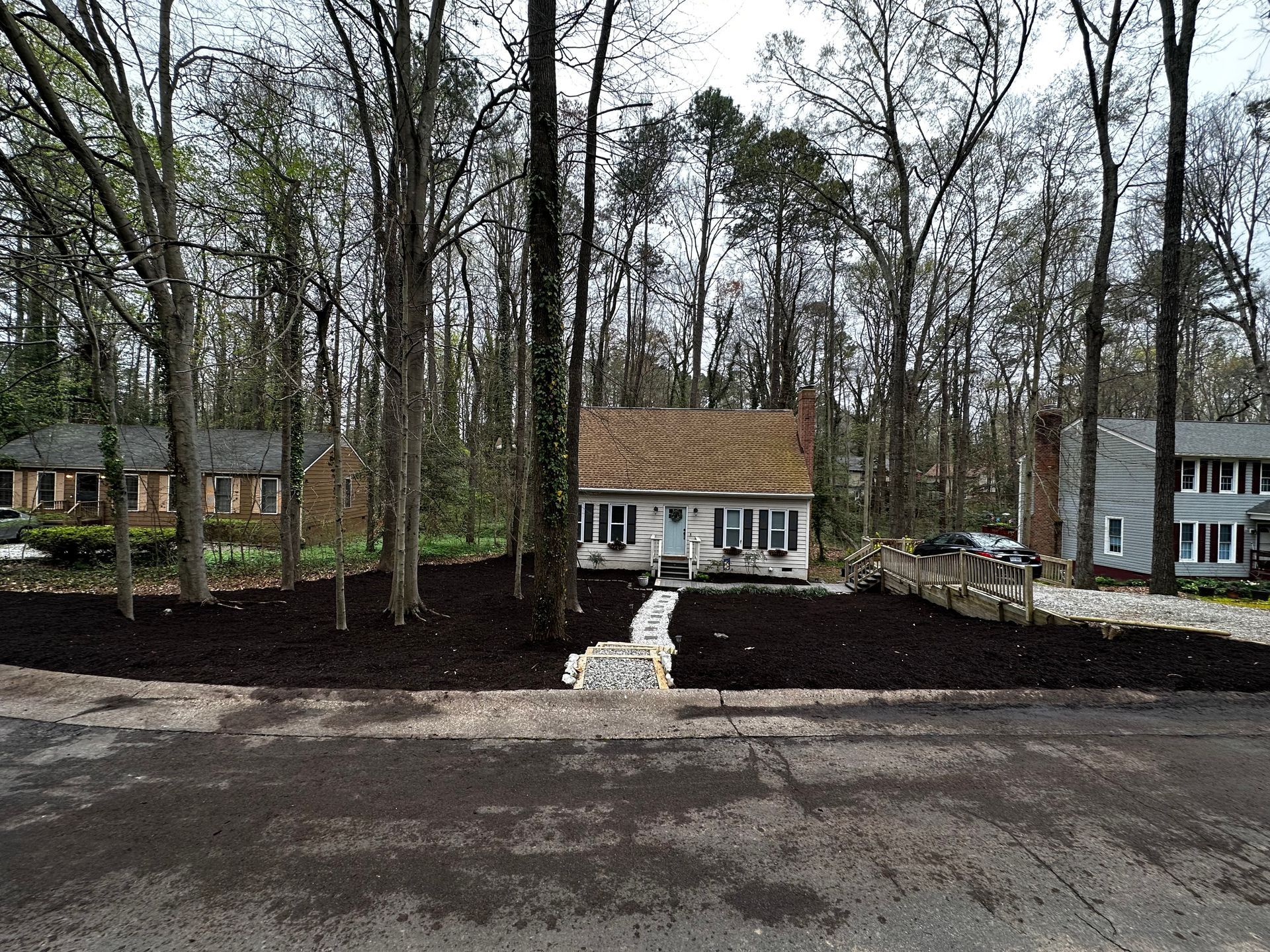 A house with a brown roof is surrounded by trees