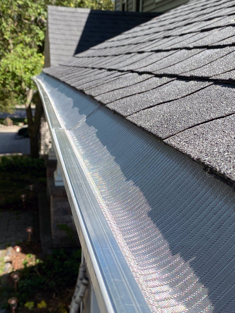 A close up of a gutter on the roof of a house.