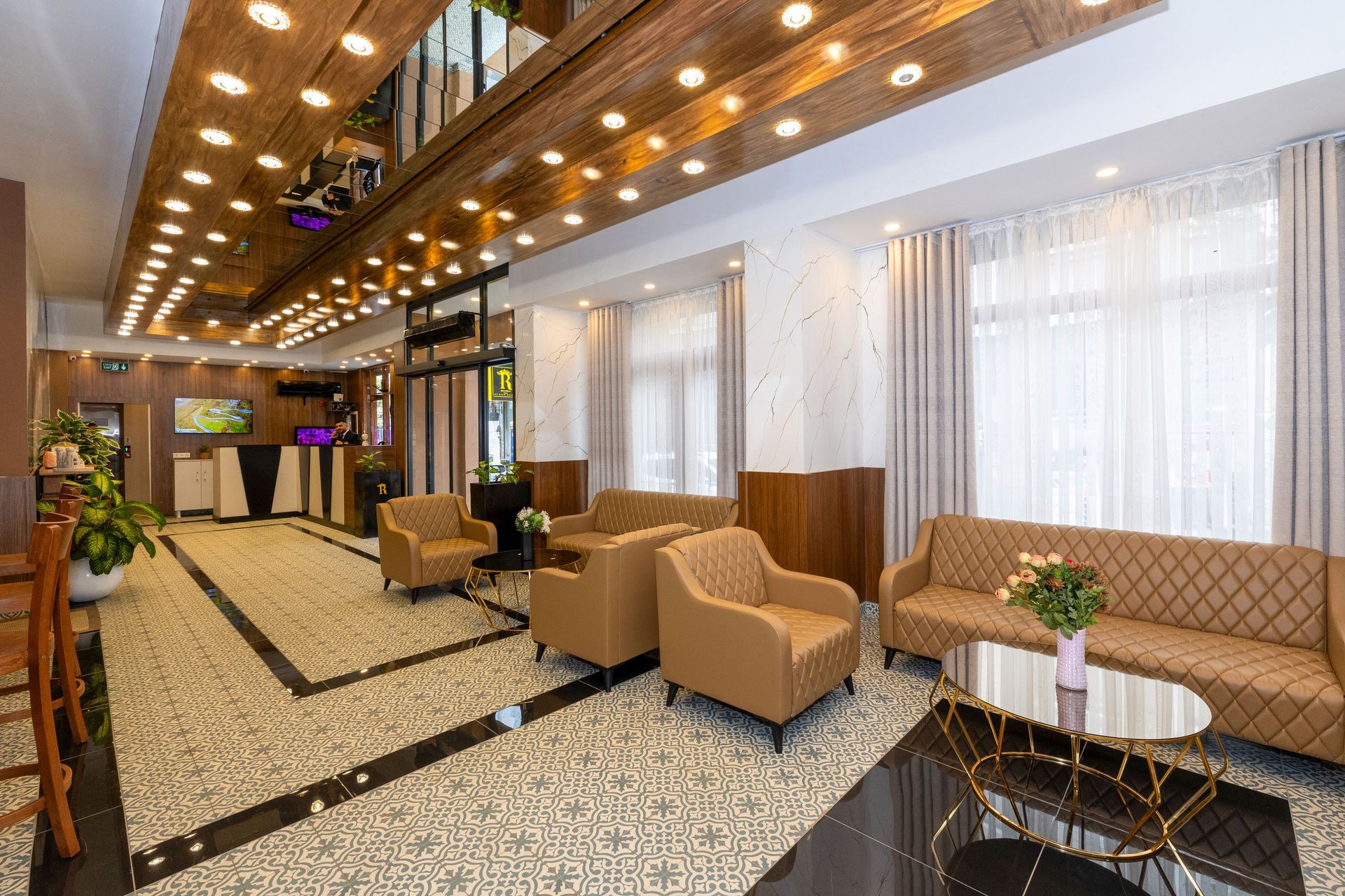 Mays Otel | Lobi | Hotel lobby with seating area; brown and beige furniture, and decorative ceiling lights.