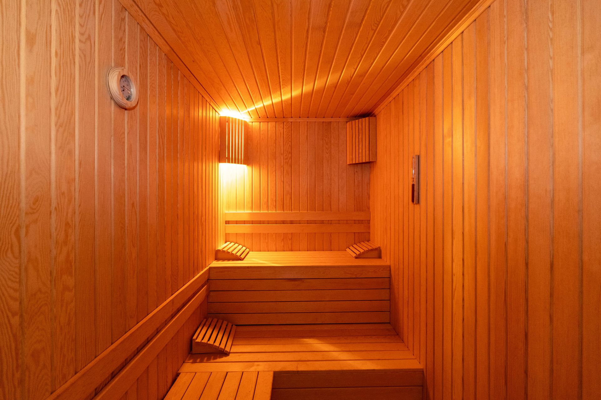 Mays Otel | Spa | Wooden sauna with benches and a heater, warm light.