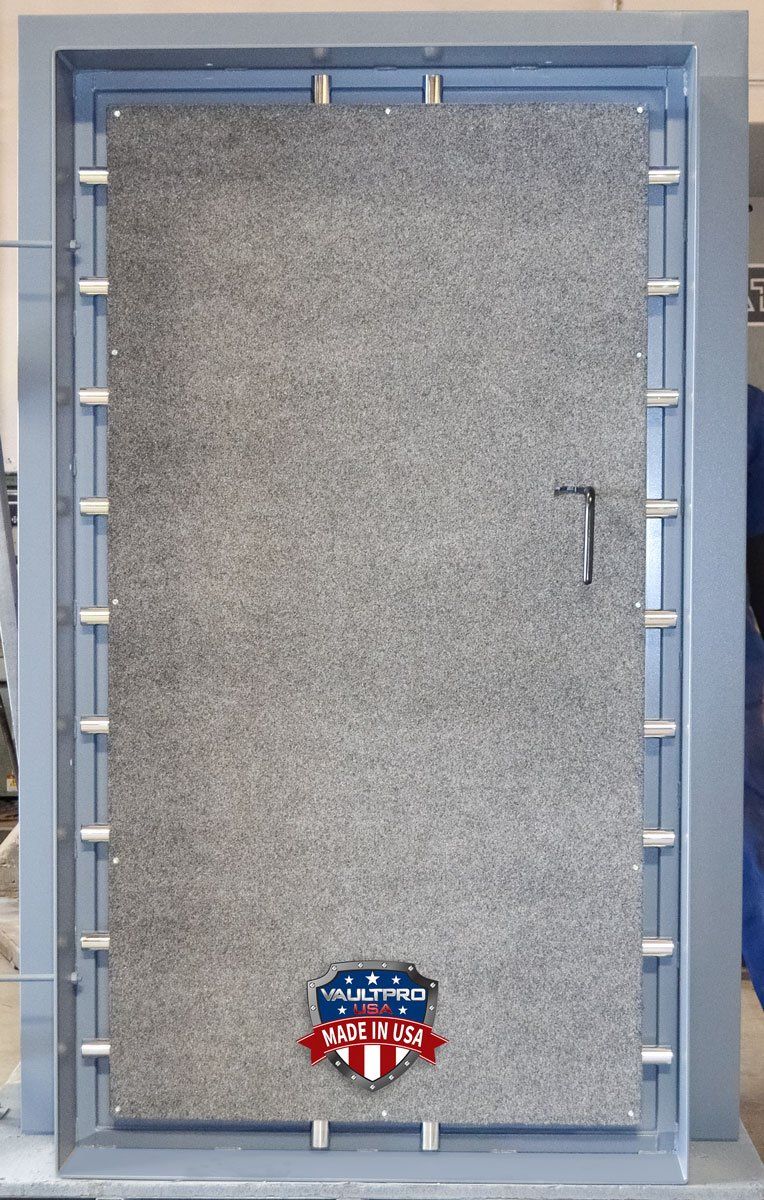 Gray felt dartboard cabinet with blue frame and small American flag badge at the bottom