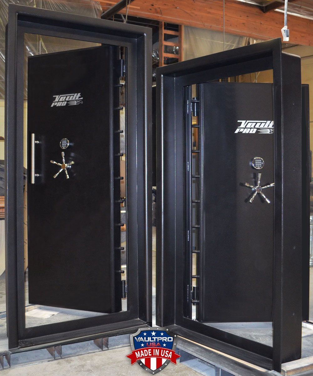 Two open black gun safes displayed side by side in a workshop
