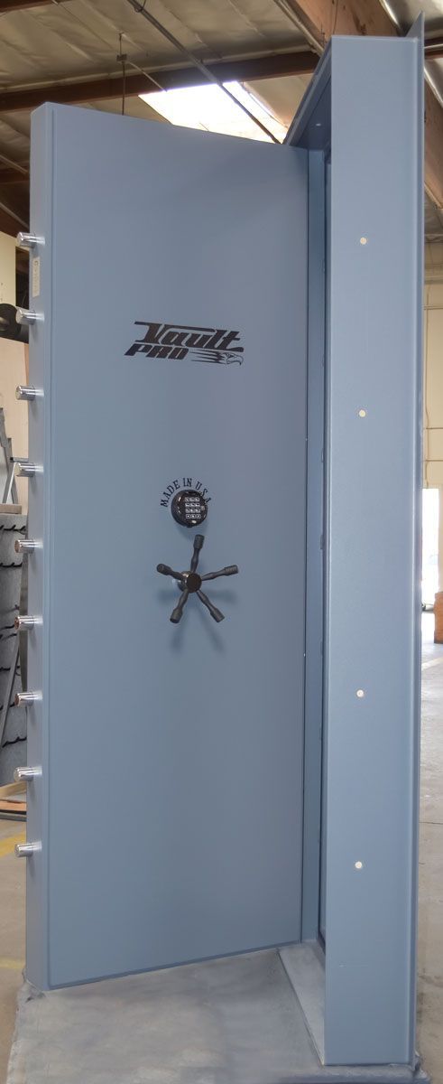 Open blue industrial cabinet or safe with large door ajar in a warehouse setting