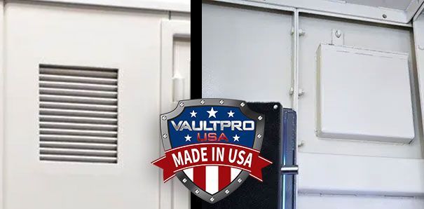 Metal sign reading “Made in USA” on a white industrial wall with vents and a panel.