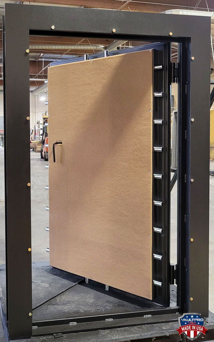 Large hinged industrial door with a tan panel, partially open in a warehouse-like setting.
