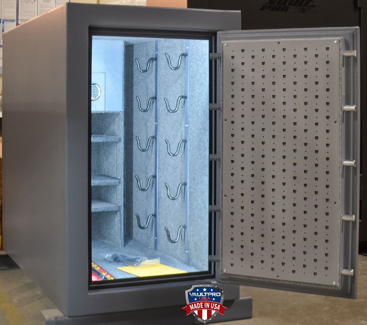 Open gray safe with door ajar, showing blue interior shelves and hanging hooks.