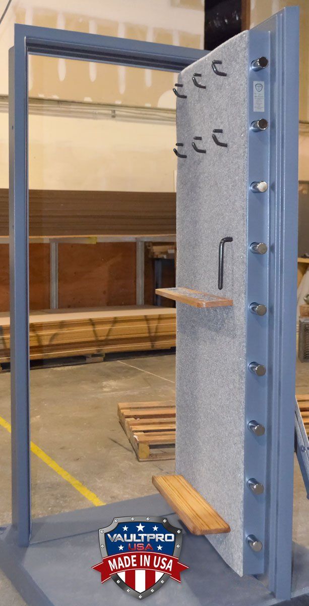 Indoor training setup with a steel frame, wooden platforms, and blue-gray padded post with metal bolts.