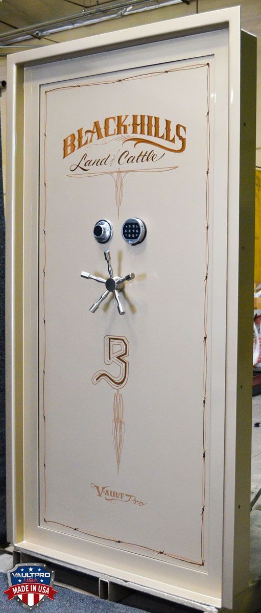 bronze color decorative safe with gold trim and silver handle, displayed indoors with ornate lettering on the door