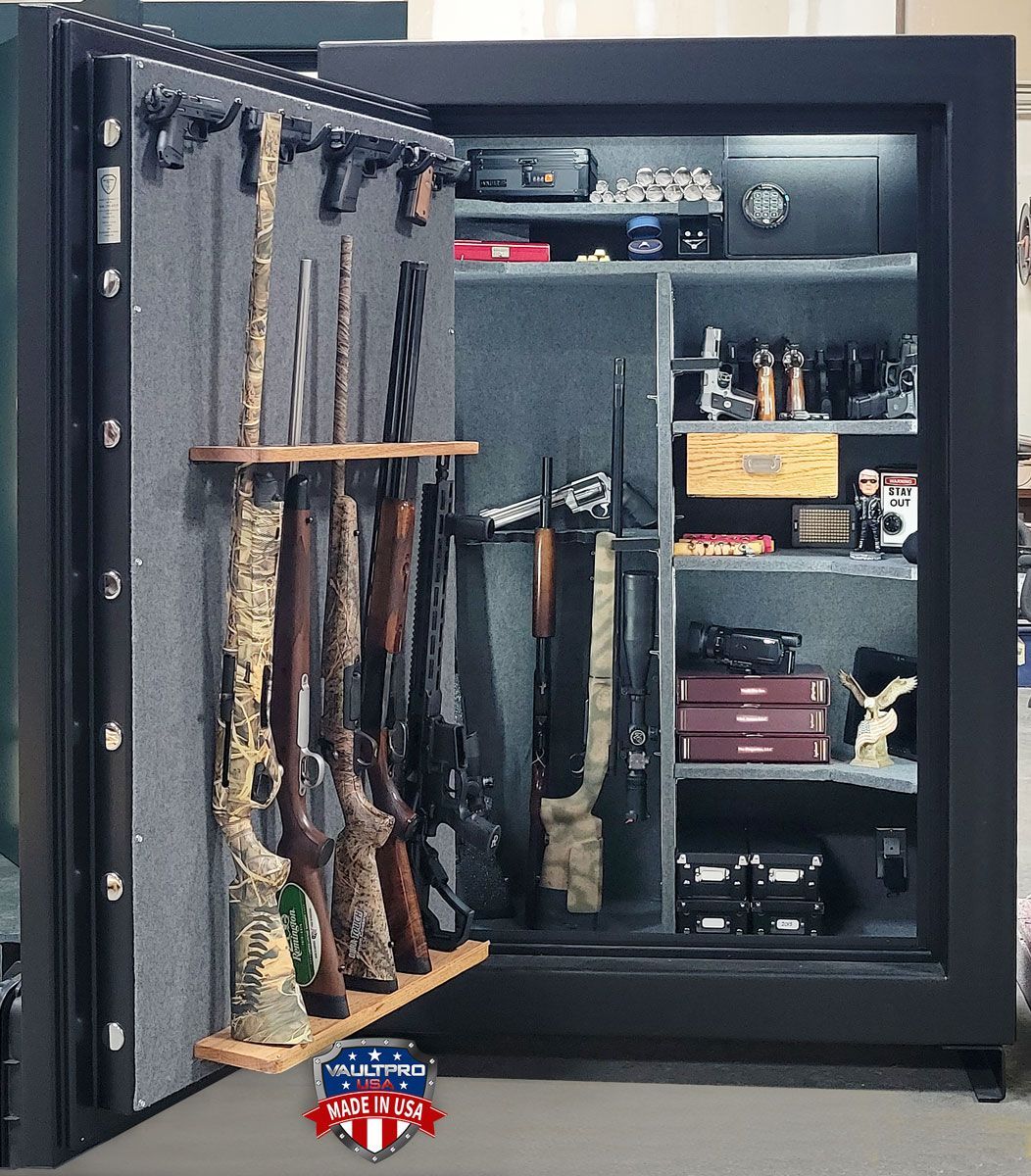 Open gun safe with several rifles and pistols organized inside