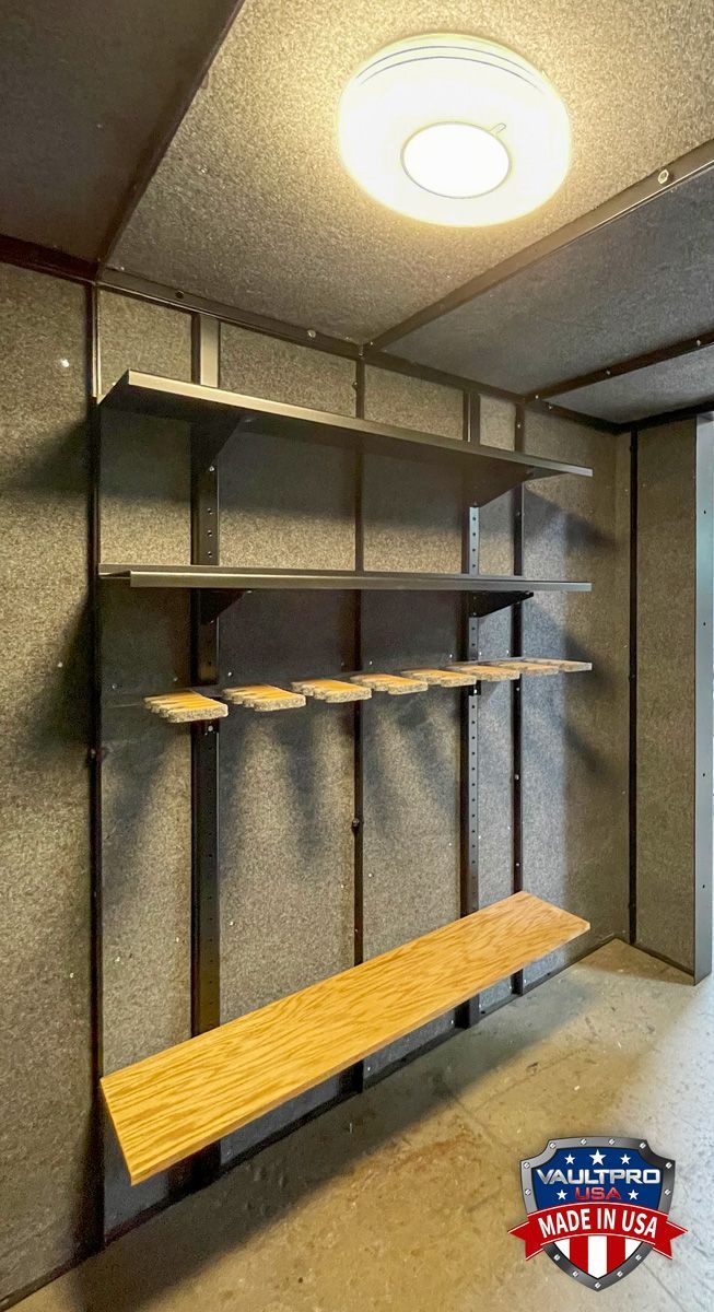 Modern entryway with built-in shelves, hanging rods, and a wooden bench under a ceiling light.
