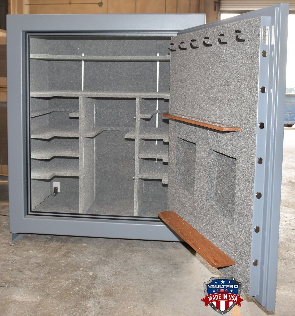 Custom long gun rack mounted on door back with pistol peg handgun holders in row near top of the door.