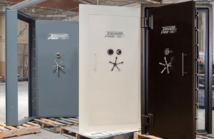 Lineup of open bank vault doors in gray, white, and black on display
