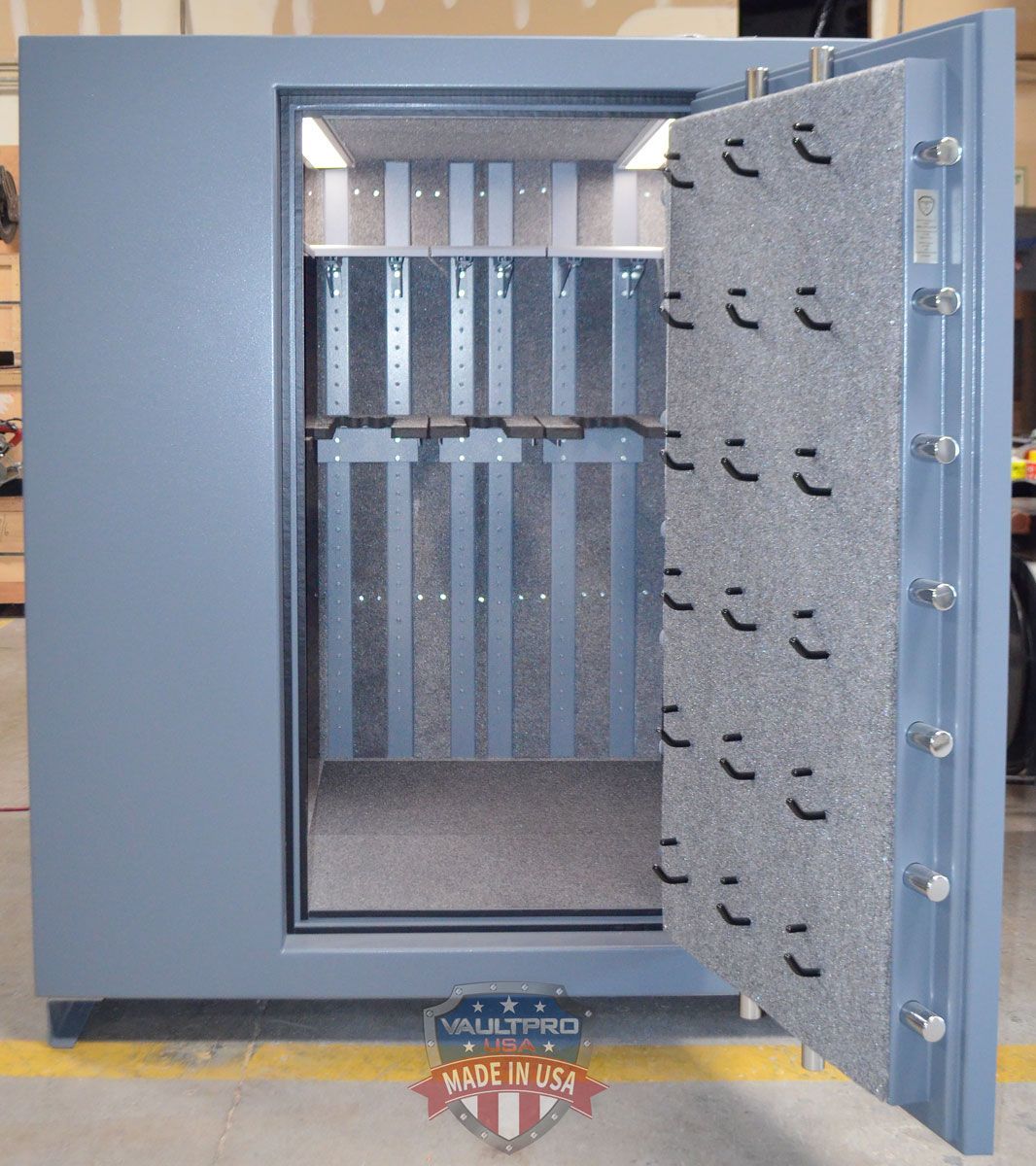 Open gray industrial vault or safe door with visible interior and locking bolts