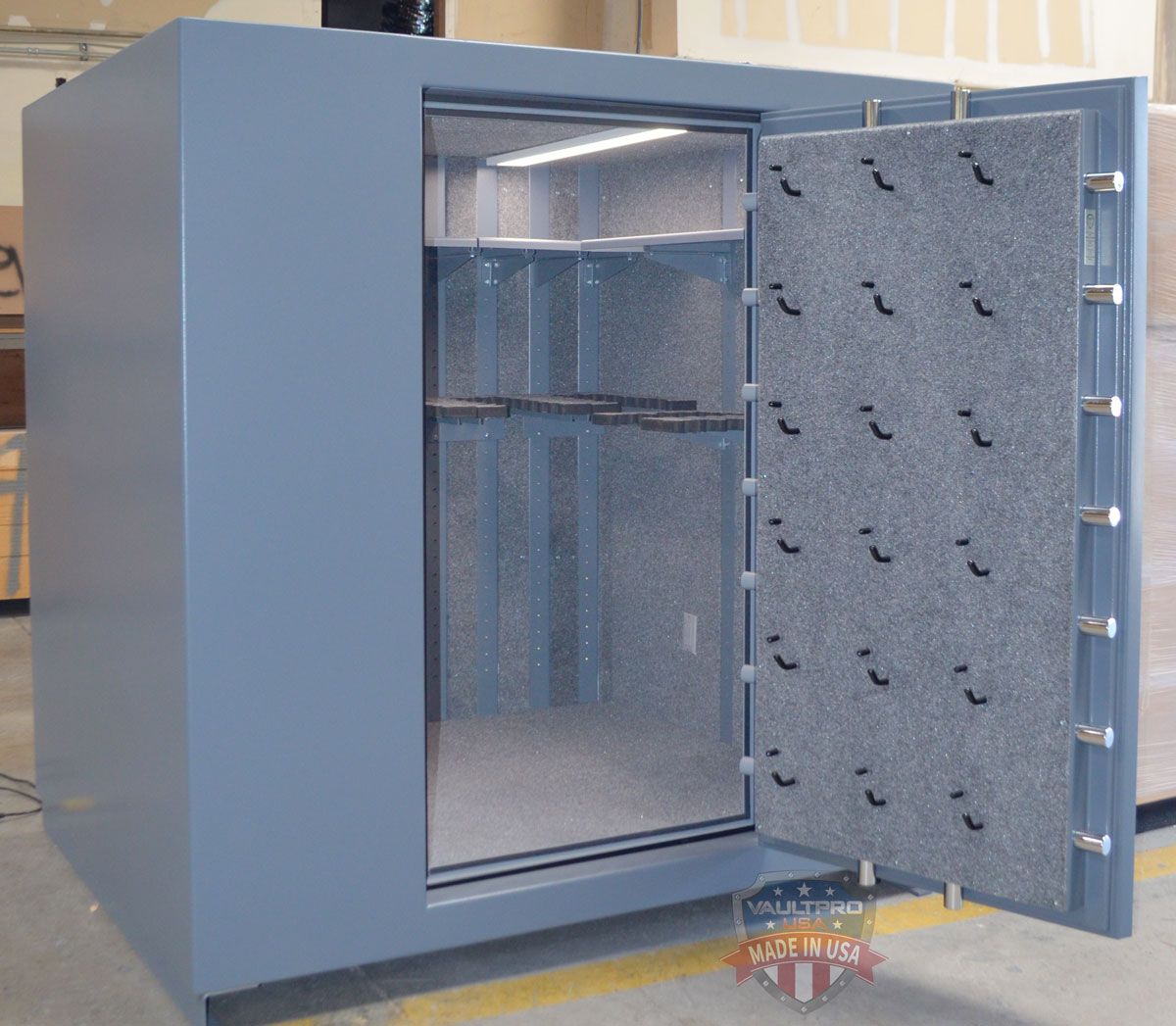 Open metal safe with door ajar, showing empty interior and shelves.
