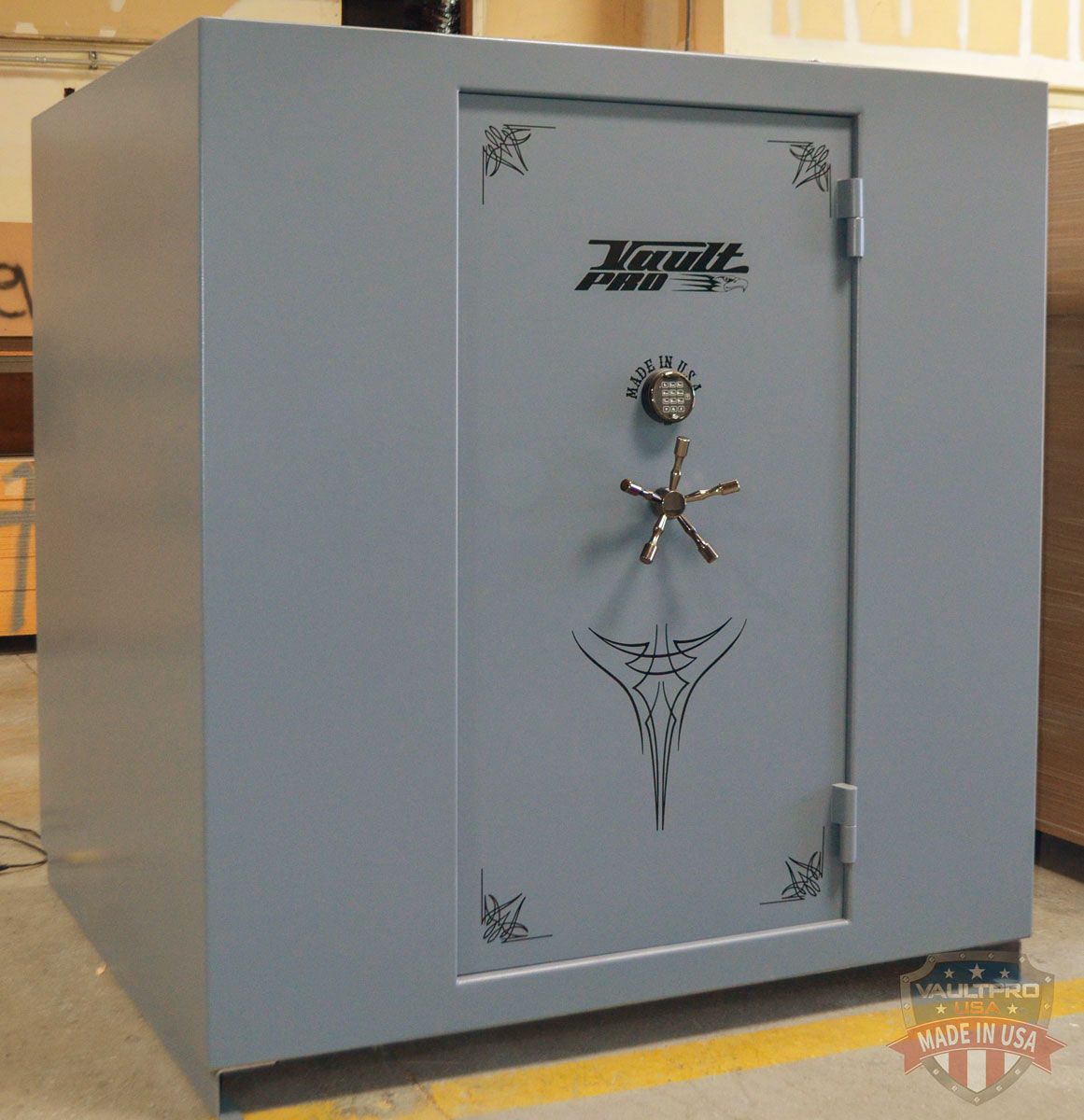 Gray safe with a decorative metal door and combination lock, standing indoors.