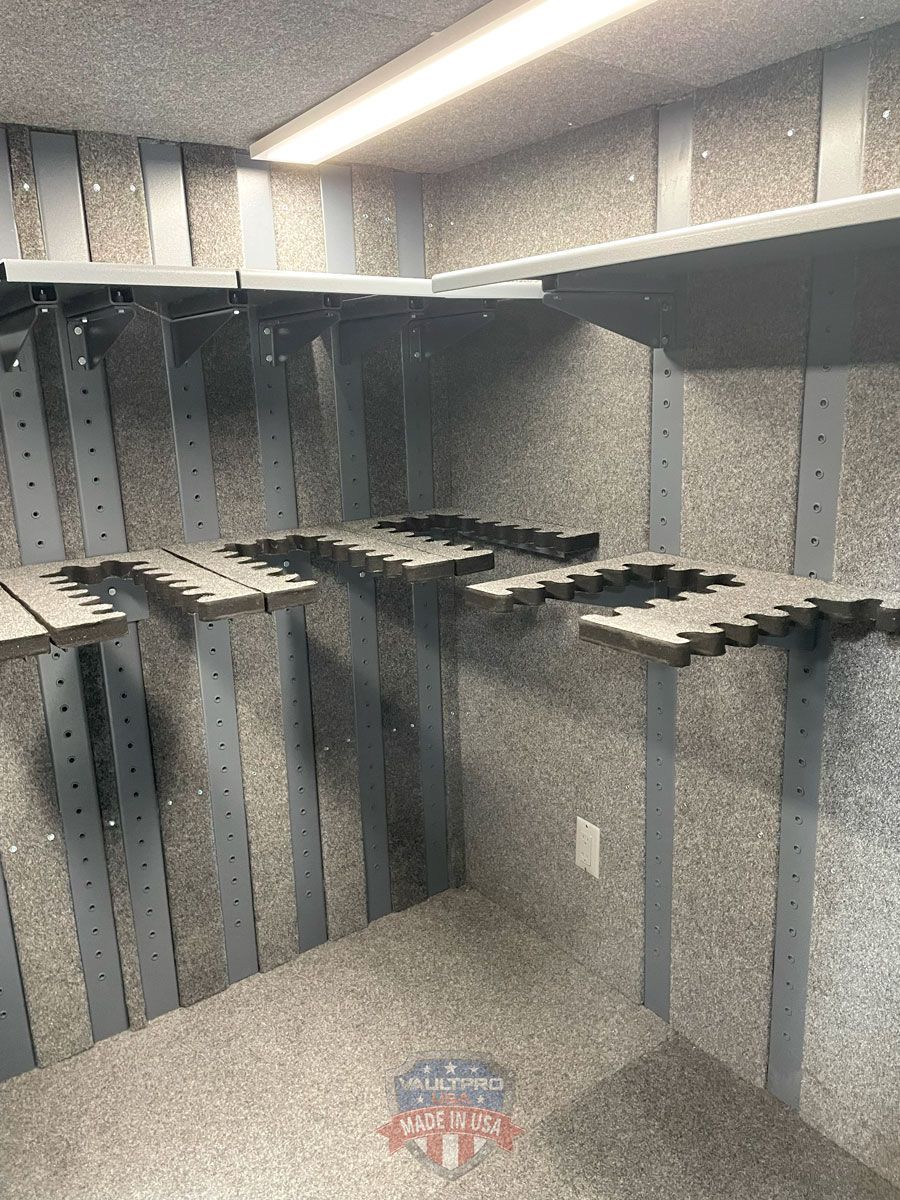 Empty walk-in closet with gray walls, shelves, and hanging rods under bright ceiling lights