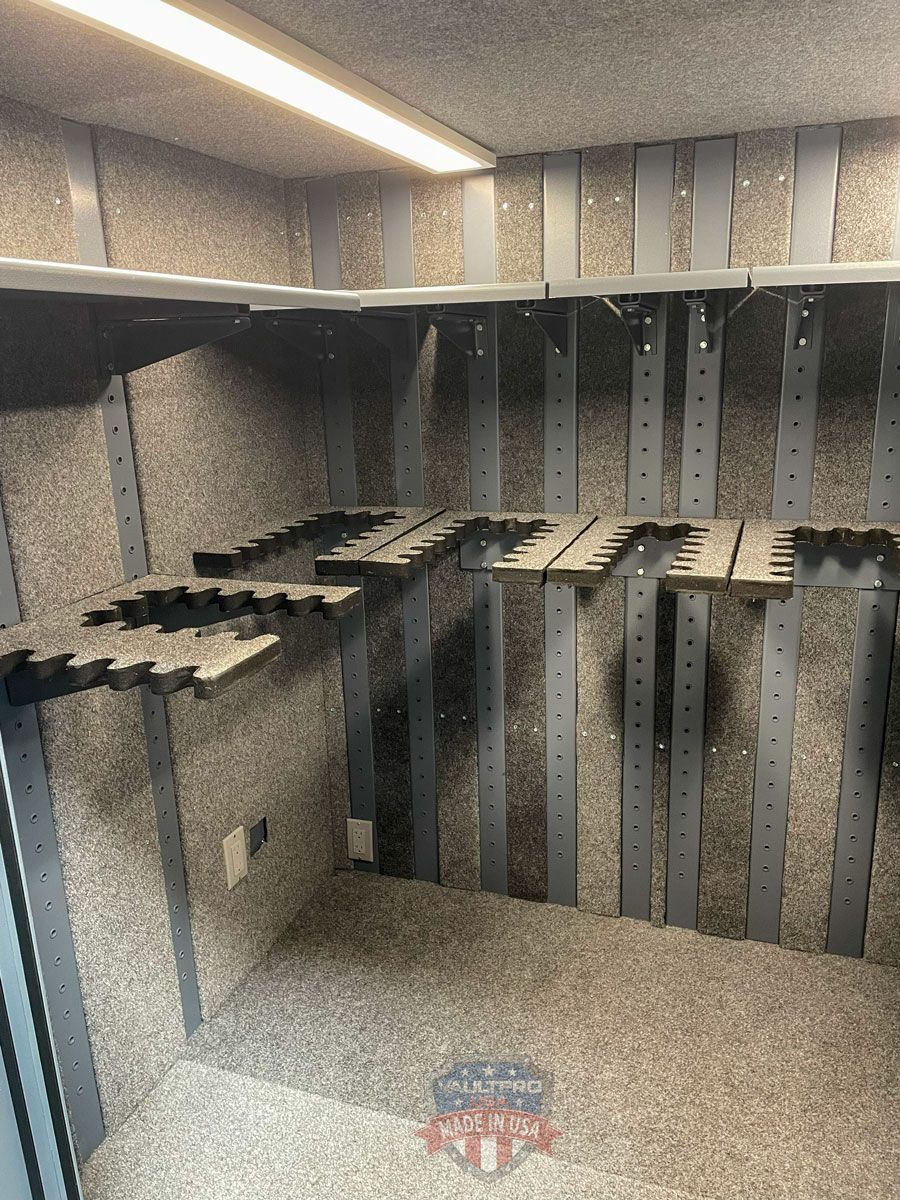 Empty gray metal shelving interior with staggered shelves and perforated supports