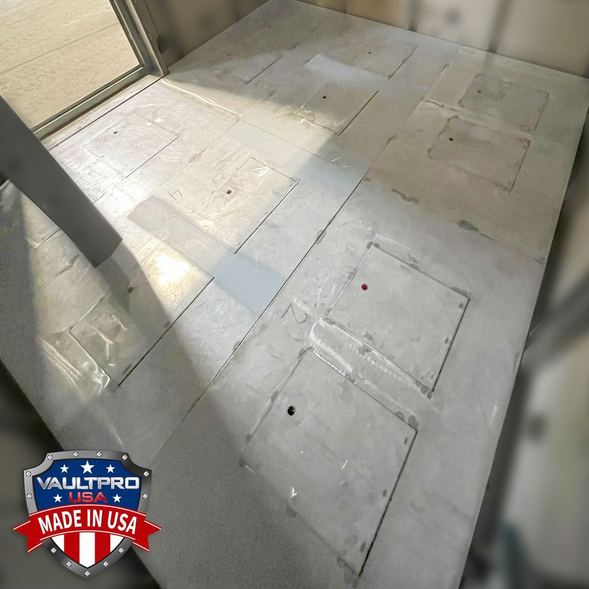 White tiled floor near a glass wall, with sunlight and a small “Made in USA” sticker in the corner