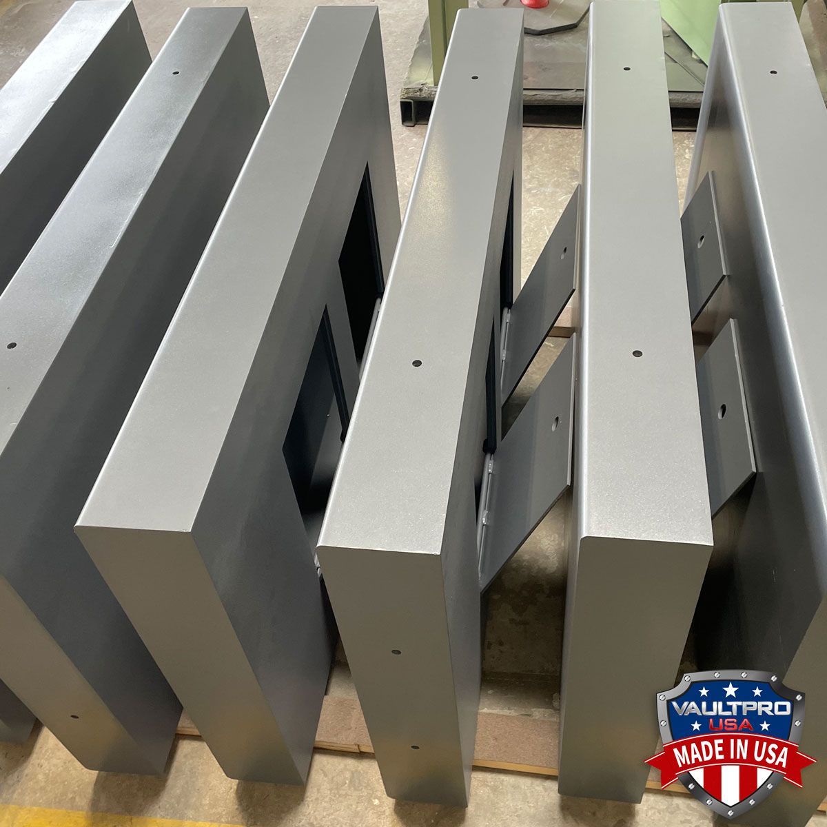 Gray metal slats stacked on a pallet in a workshop, with a small “Made in USA” sticker.