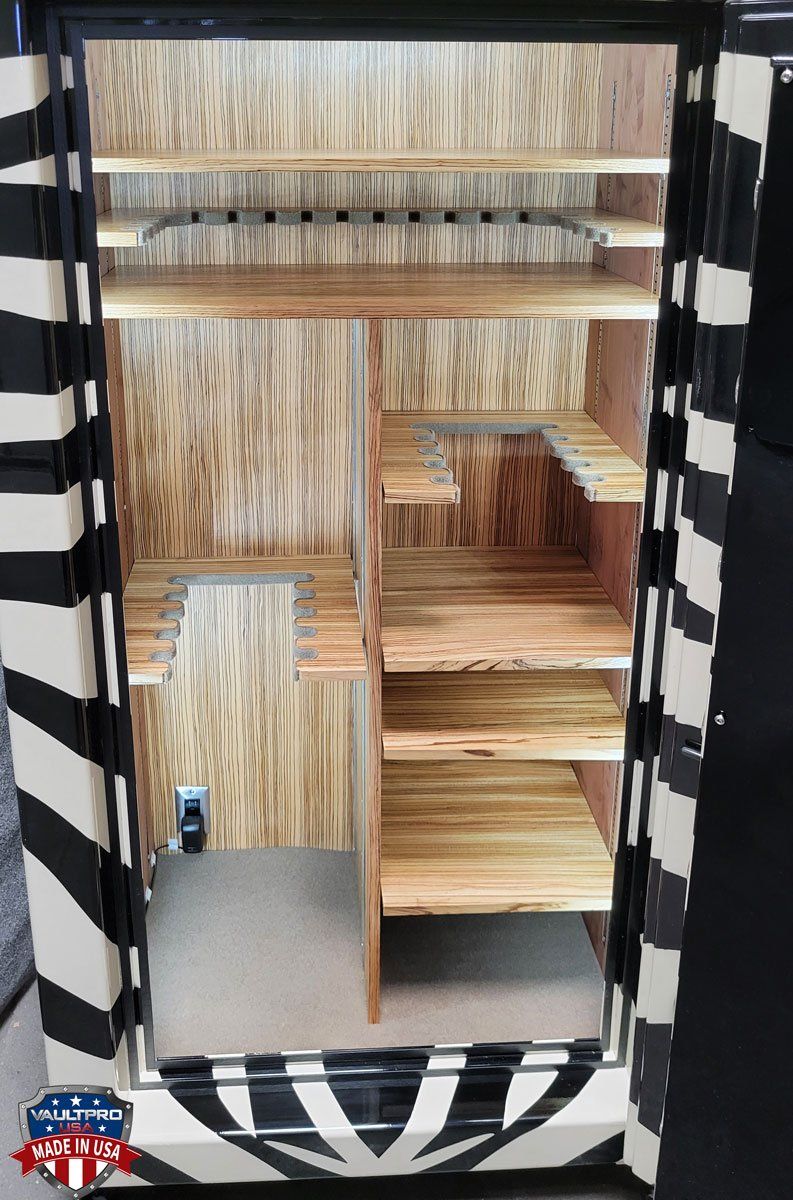 Straw-filled kennel interior with a gray floor and black-and-white striped frame.