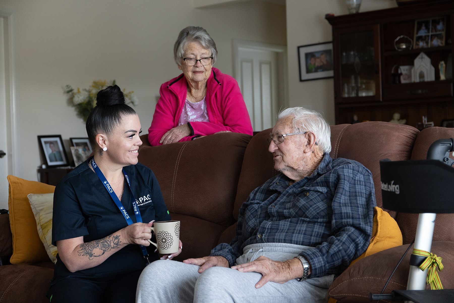 Care Worker With a Client in a Living Room, Talking With Coffee Mug — Premium Aged & Community Services In Gosford, NSW